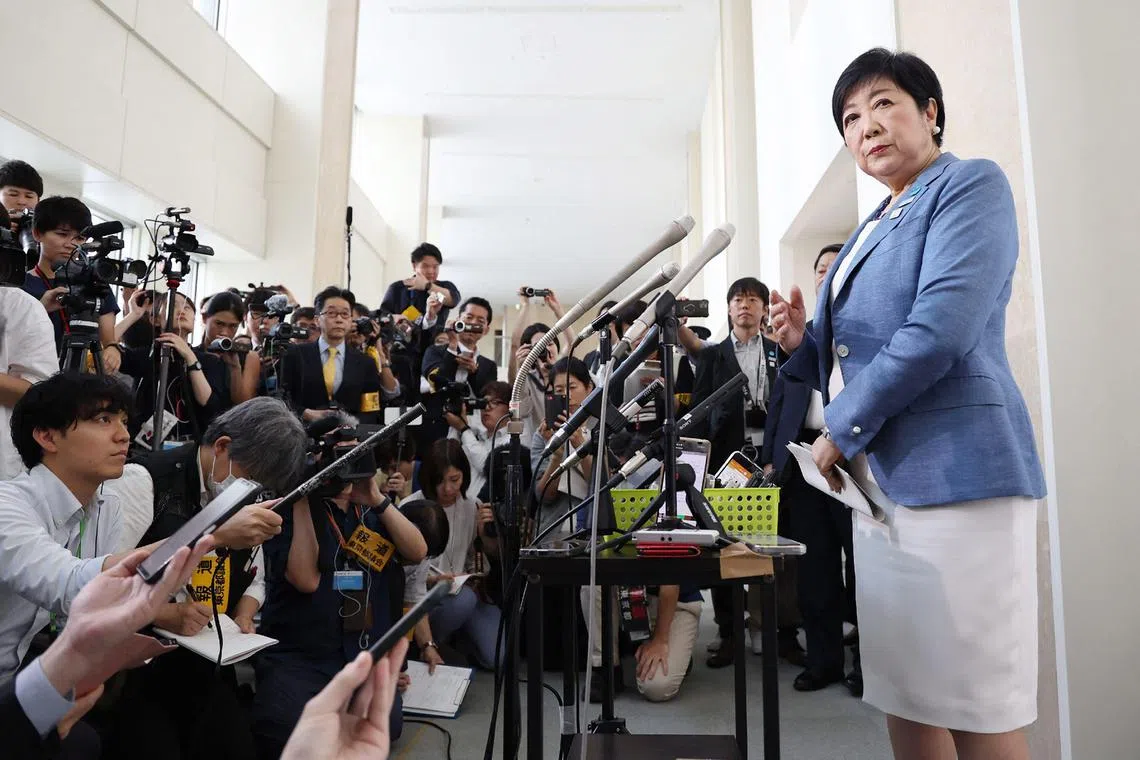 Tokyo Governor Yuriko Koike (R) speaks to the media in the Shinjuku area of Tokyo on June 12, 2024, after announcing she would run for a third four-year term ahead of the planned July 7 gubernatorial election. (Photo by JIJI Press / AFP) / Japan OUT
