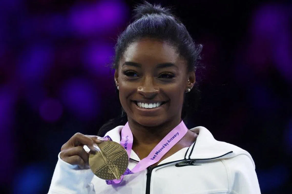 FILE PHOTO: Gymnastics - 2023 World Artistic Gymnastics Championships - Sportpaleis, Antwerp, Belgium - October 8, 2023 Gold medallist Simone Biles of the U.S. celebrates during the medal ceremony after winning the floor exercise at the women's apparatus finals REUTERS/Yves Herman/File Photo