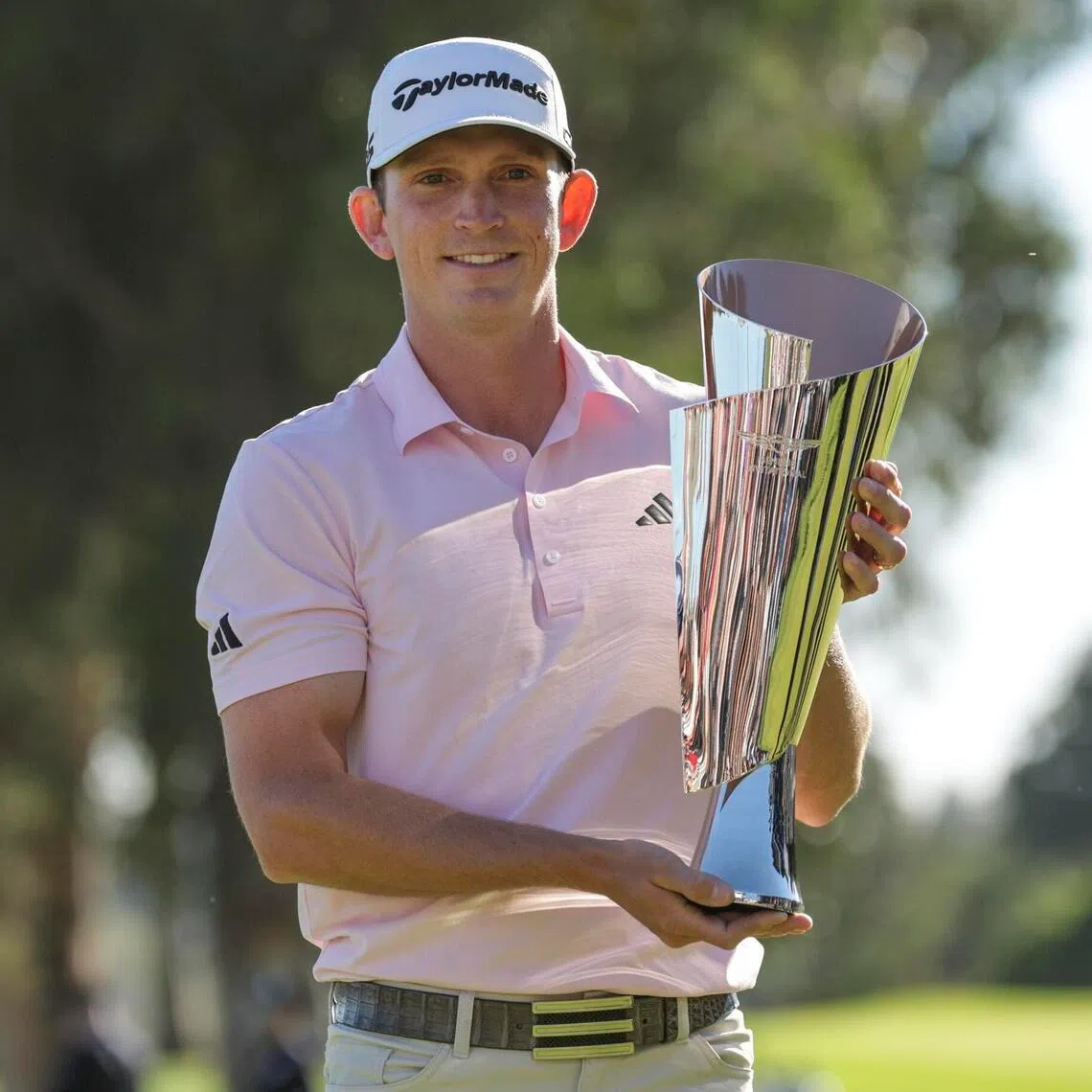 American athlete Jacob Bridgeman poses with the winner's trophy for the final round of the 2026 Genesis Invitational at Riviera Country Club in Los Angeles, California, USA, 22 February 2026.  EPA/CHRIS TORRES