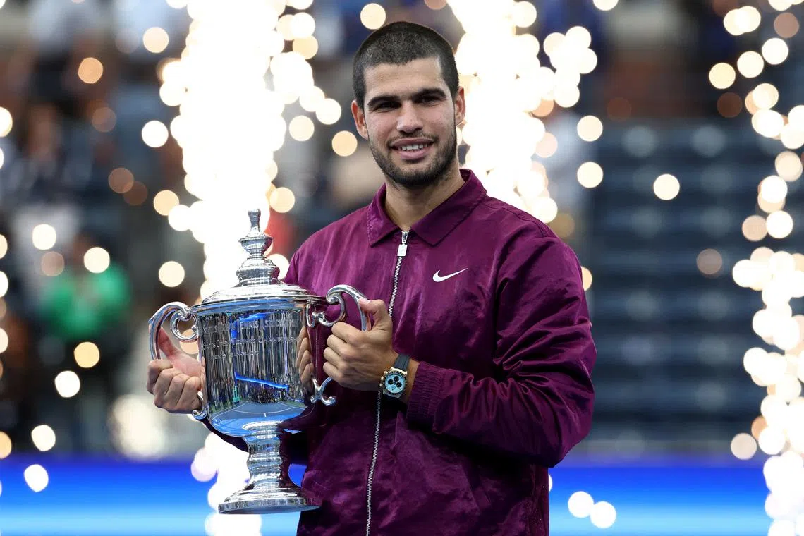 Tennis - U.S. Open - Flushing Meadows, New York, United States - September 7, 2025 Spain's Carlos Alcaraz celebrates with the trophy after winning the men's singles final REUTERS/Kevin Lamarque