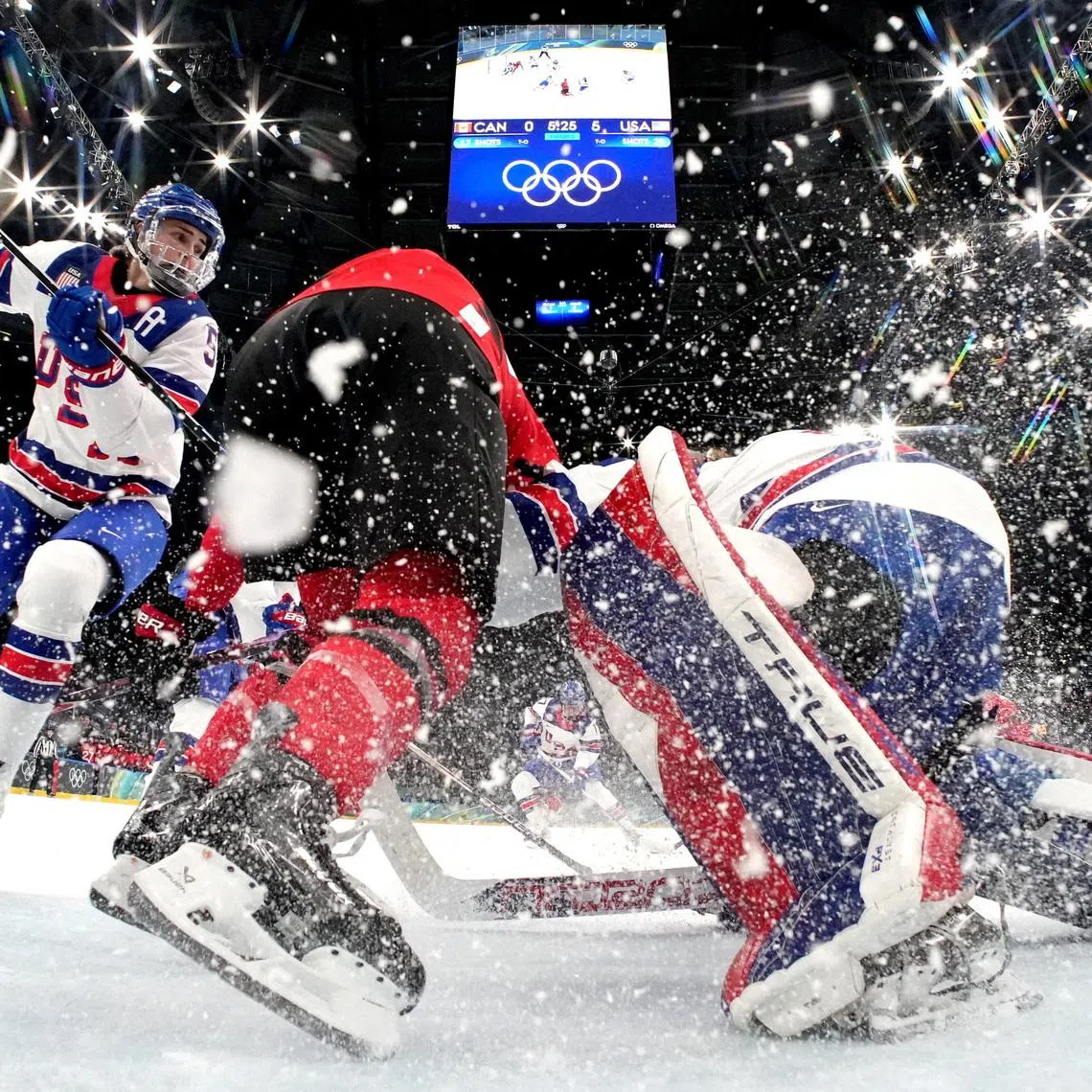 Milano Cortina 2026 Olympics - Ice Hockey - Women's Preliminary Round - Group A - Canada vs United States - Milano Santagiulia Ice Hockey Arena, Milan, Italy - February 10, 2026. Megan Keller of United States and Aerin Frankel of United States in action with a member of team Canada REUTERS/Mike Segar/Pool     TPX IMAGES OF THE DAY