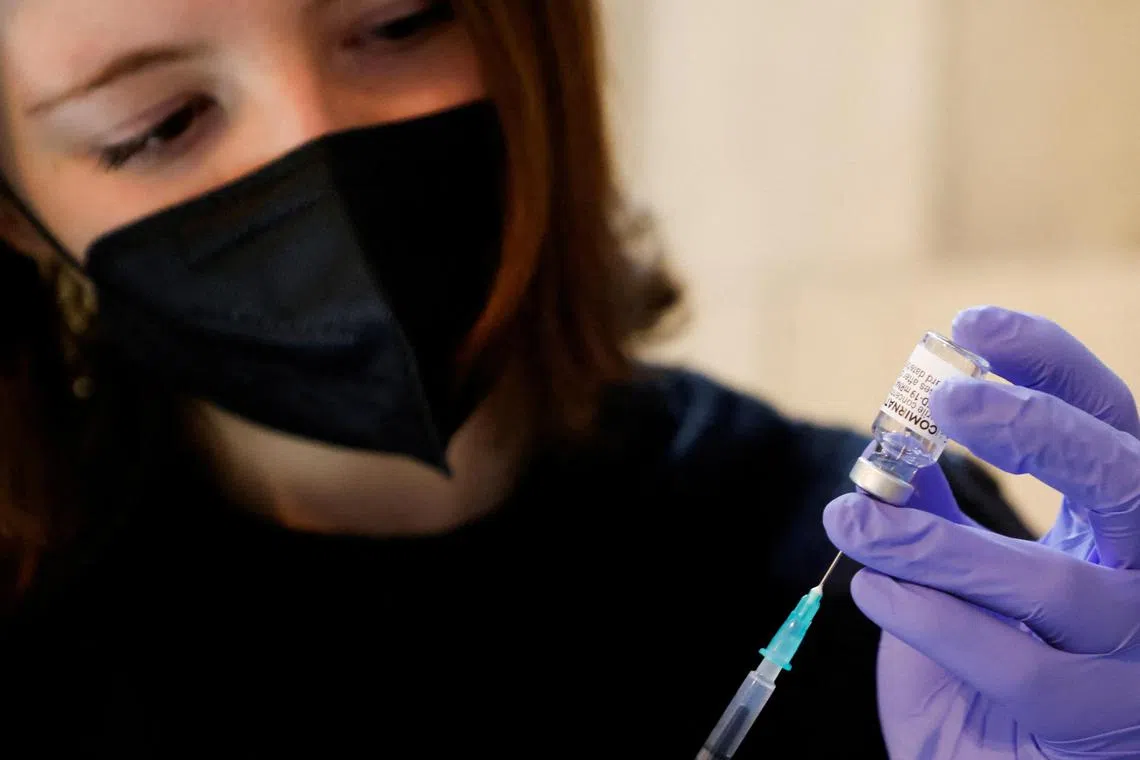 FILE PHOTO: A volunteer prepares a syringe containing a dose of Comirnaty, the Pfizer-BioNTech vaccine against the coronavirus disease (COVID-19), at a vaccination center in St. Stephen's Cathedral, in Vienna, Austria February 5, 2022.  REUTERS/Leonhard Foeger/File Photo