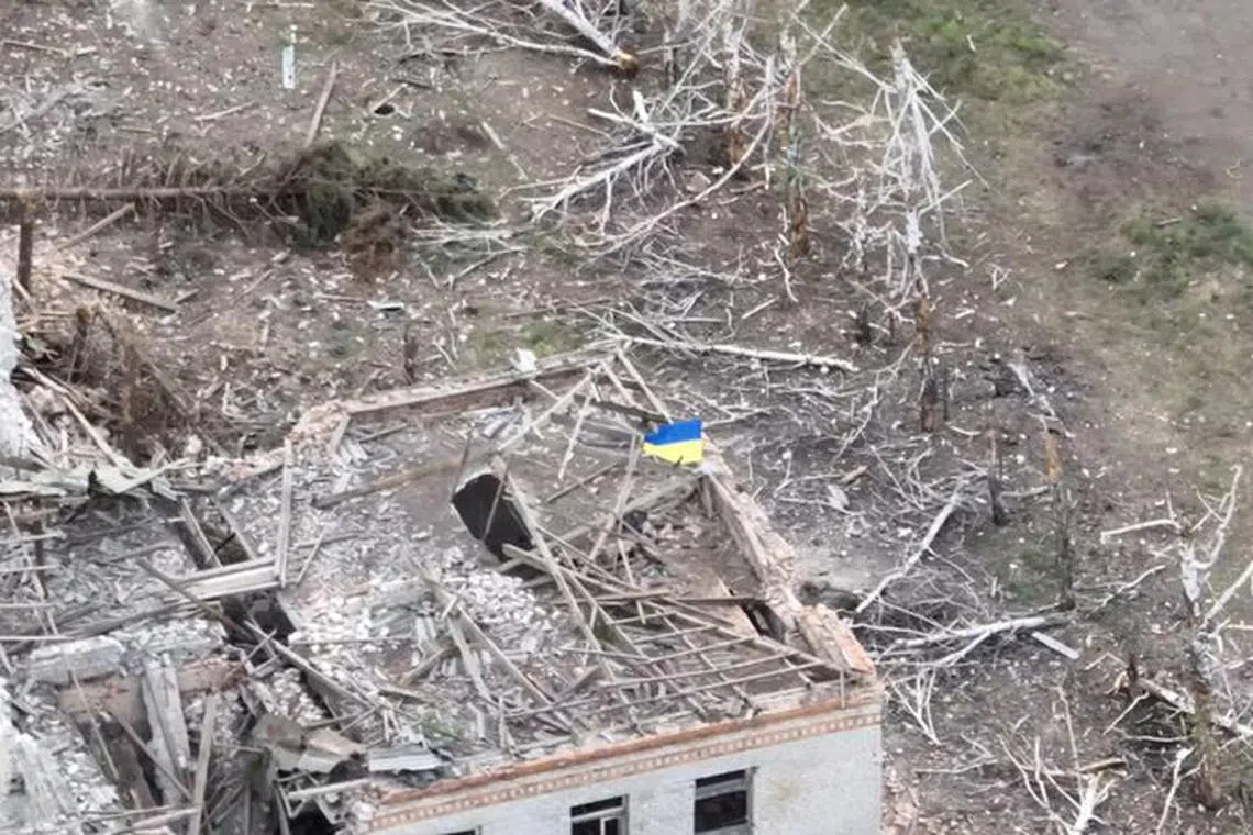 Ukrainian forces raise the national flag in the settlement of Robotyne, Zaporizhzhia region, Ukraine, in this screen grab taken from a social media video released August 23, 2023. Telegram Valerii Zaluzhnyi/via REUTERS/File Photo