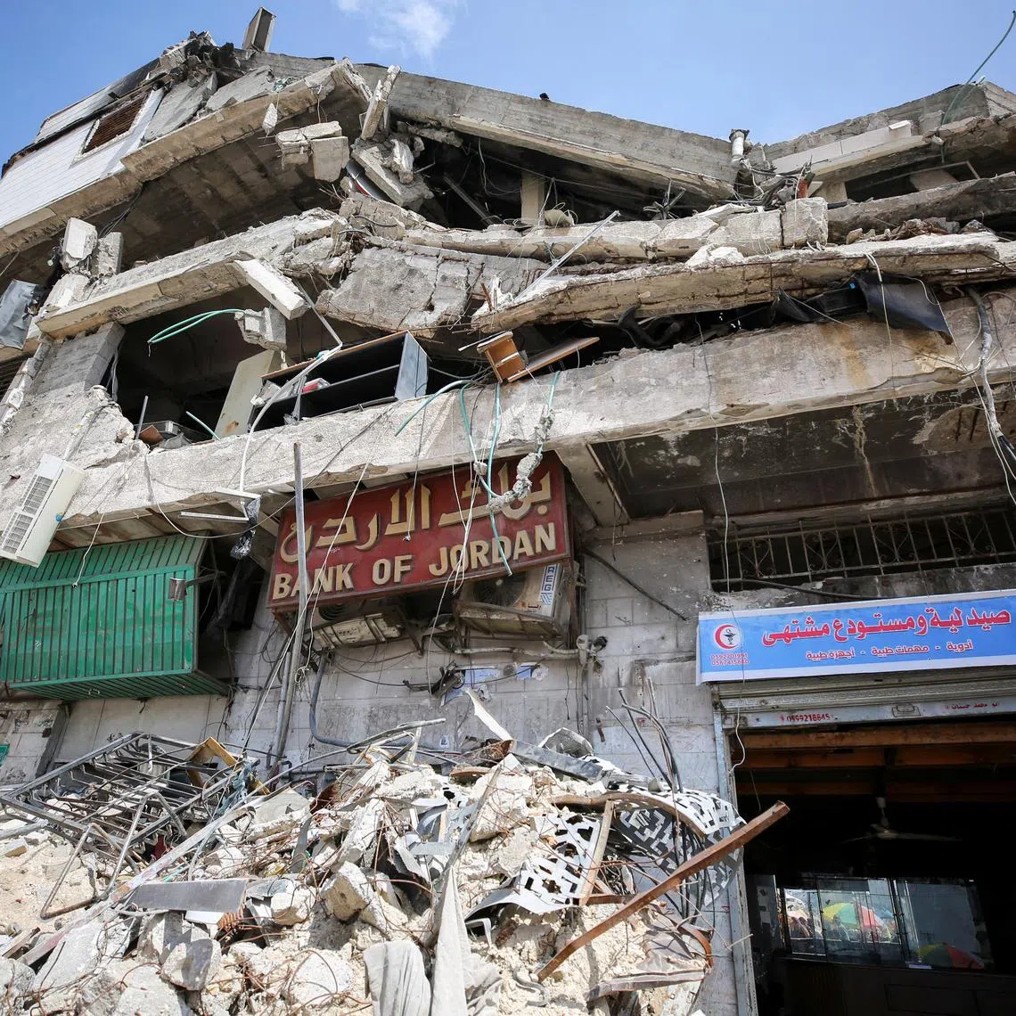 A building housing Bank of Jordan stands in ruins after it was destroyed in an Israeli strike, amid a cash crunch caused by the destruction and closure of banks, as conflict between Israel and Hamas continues, in Gaza City May 5, 2024. REUTERS/Dawoud Abu Alkas