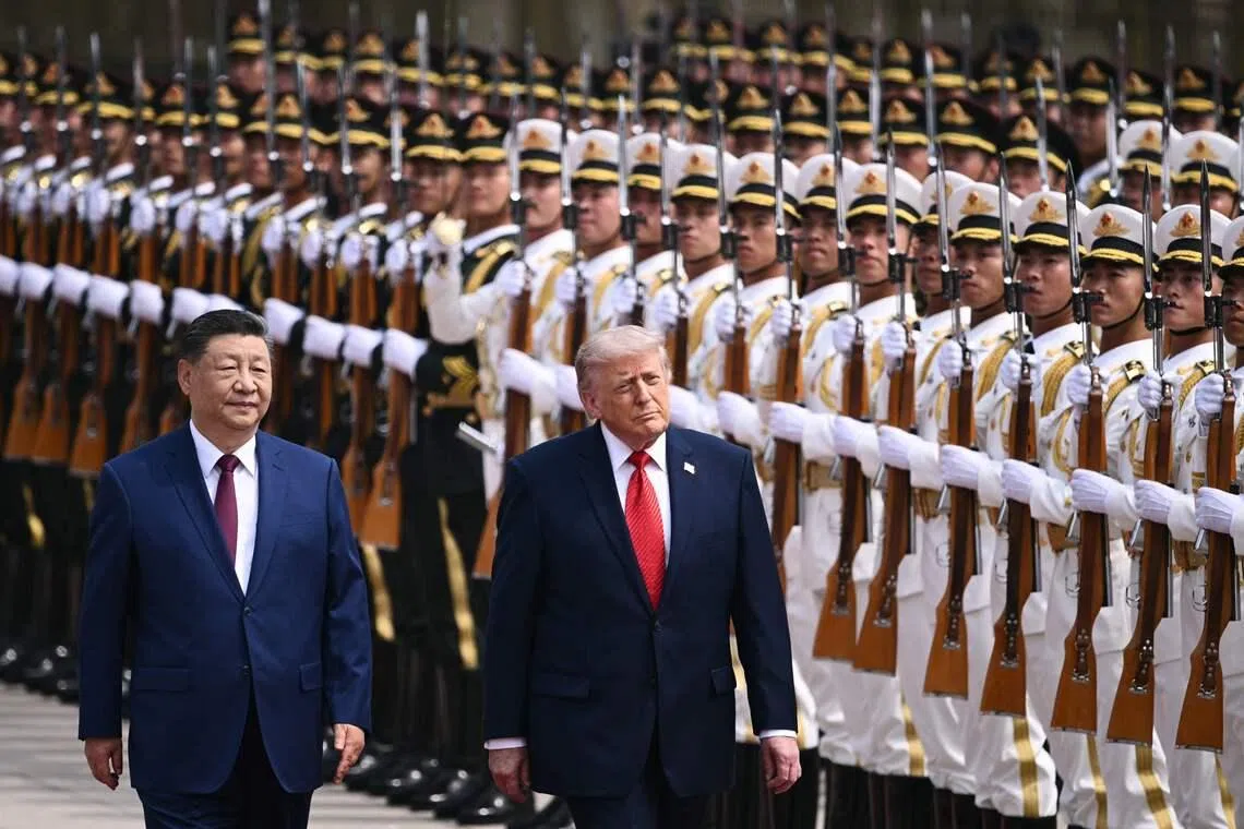 US President Donald Trump (right) and China's President Xi Jinping inspecting a guard of honour during a welcome ceremony at the Great Hall of the People in Beijing on May 14.