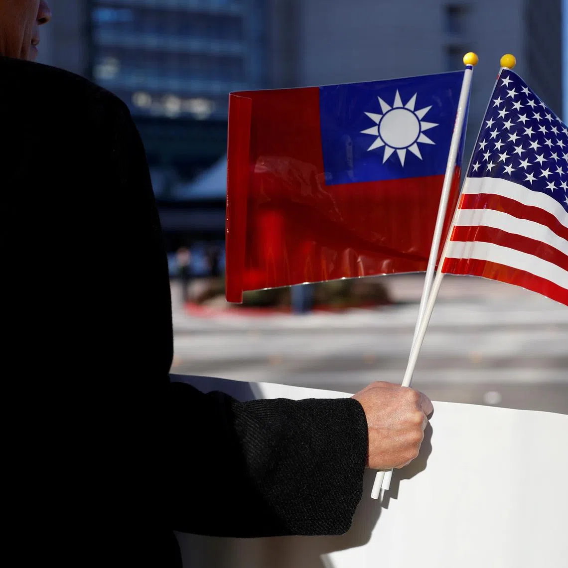 A demonstrator holds flags of Taiwan and the United States in California, U.S., January 14, 2017. REUTERS/Stephen Lam