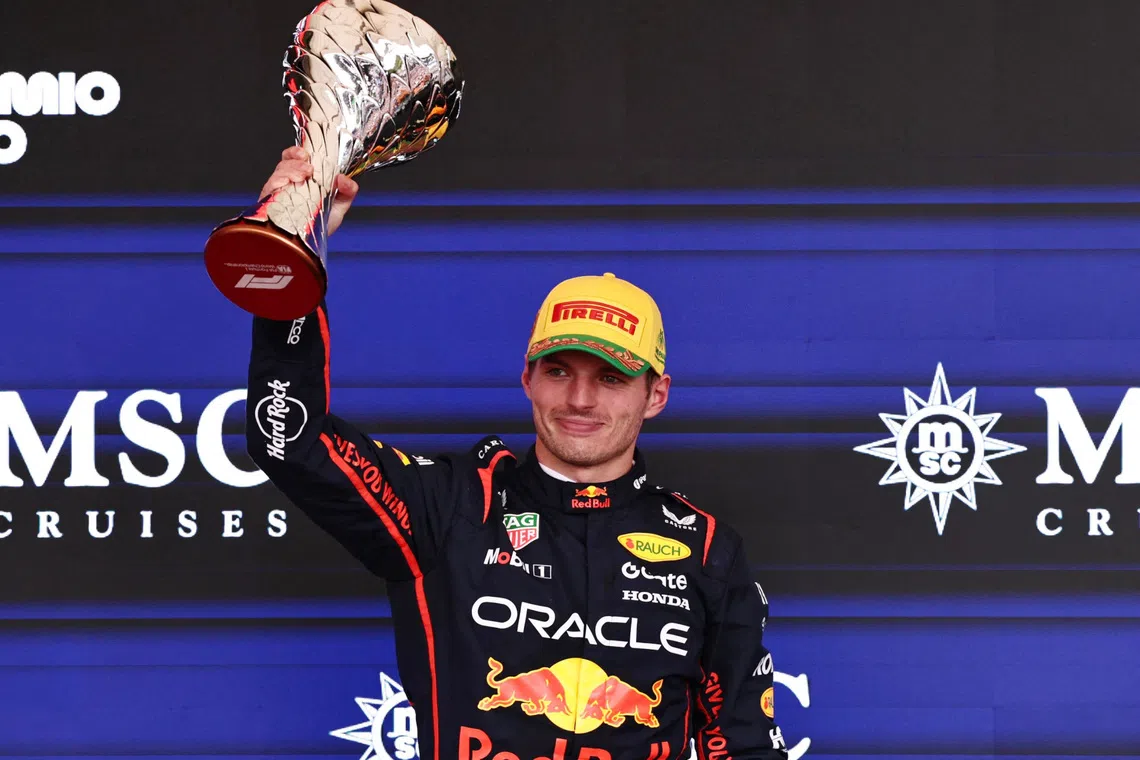Formula One F1 - Sao Paulo Grand Prix - Autodromo Jose Carlos Pace, Sao Paulo, Brazil - November 9, 2025 Red Bull's Max Verstappen celebrates on the podium with a trophy after finishing third in the Sao Paulo Grand Prix REUTERS/Jean Carniel