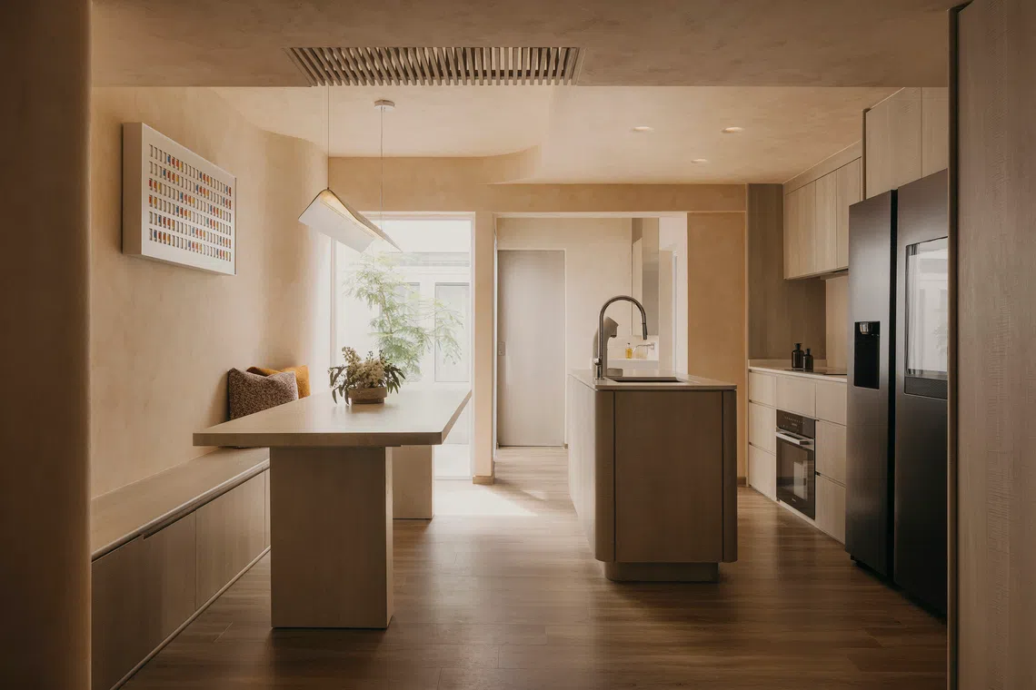 The kitchen and dining area are part of an open-concept zone demarcated by a quartz island, with a central air well at the heart of the home.