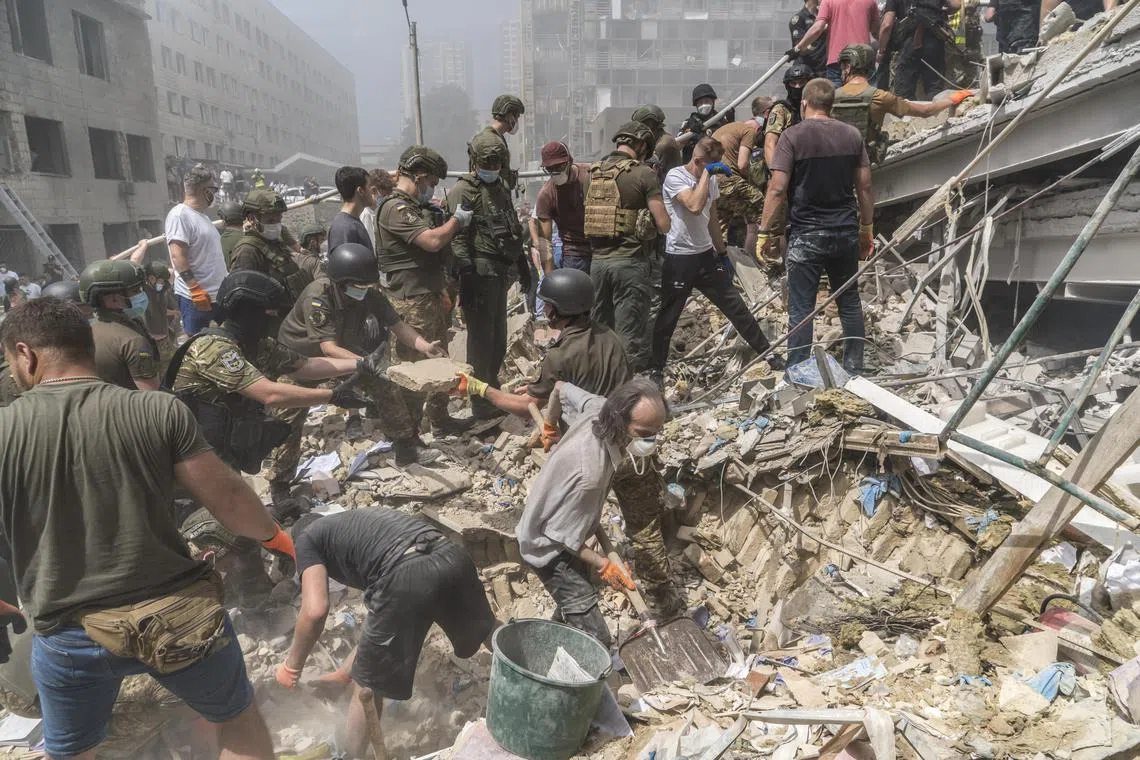 Rescuers and volunteers clear rubble and search for survivors after a Russian missile strike on Okhmatdyt Children's Hospital in Kyiv, Ukraine.