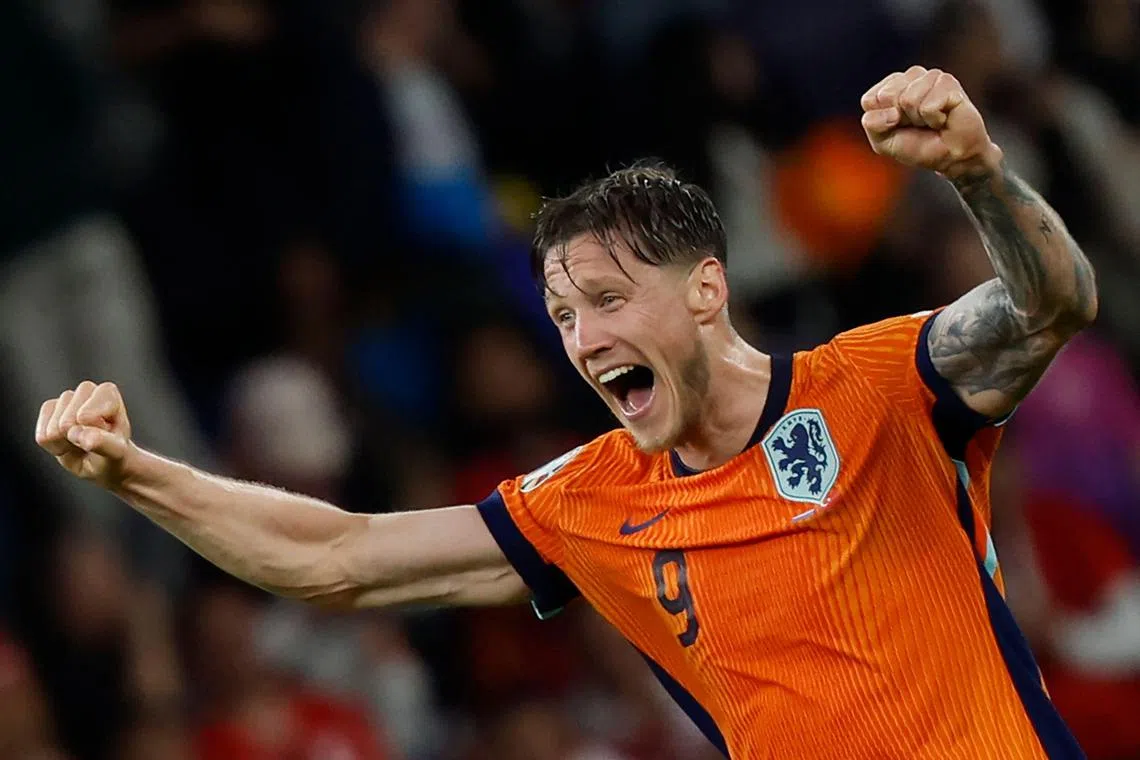 Netherlands' forward Wout Weghorst celebrates at the final whistle.