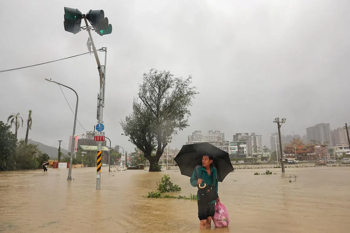 A man wading through the floodwaters after Typhoon Krathon made landfall in Kaohsiung, Taiwan, on Oct 3, 2024. 