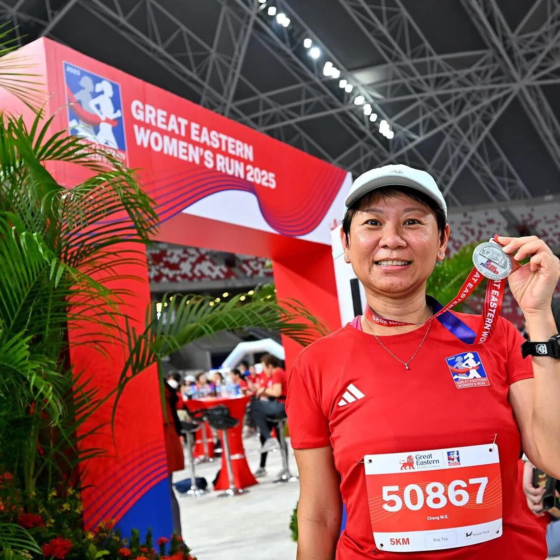 jcrun09 - Mdm Cheng Meow Eng posing with her medal after completing the 5km run at the Great Eastern Women's Run 2025.
Credit: GREAT EASTERN