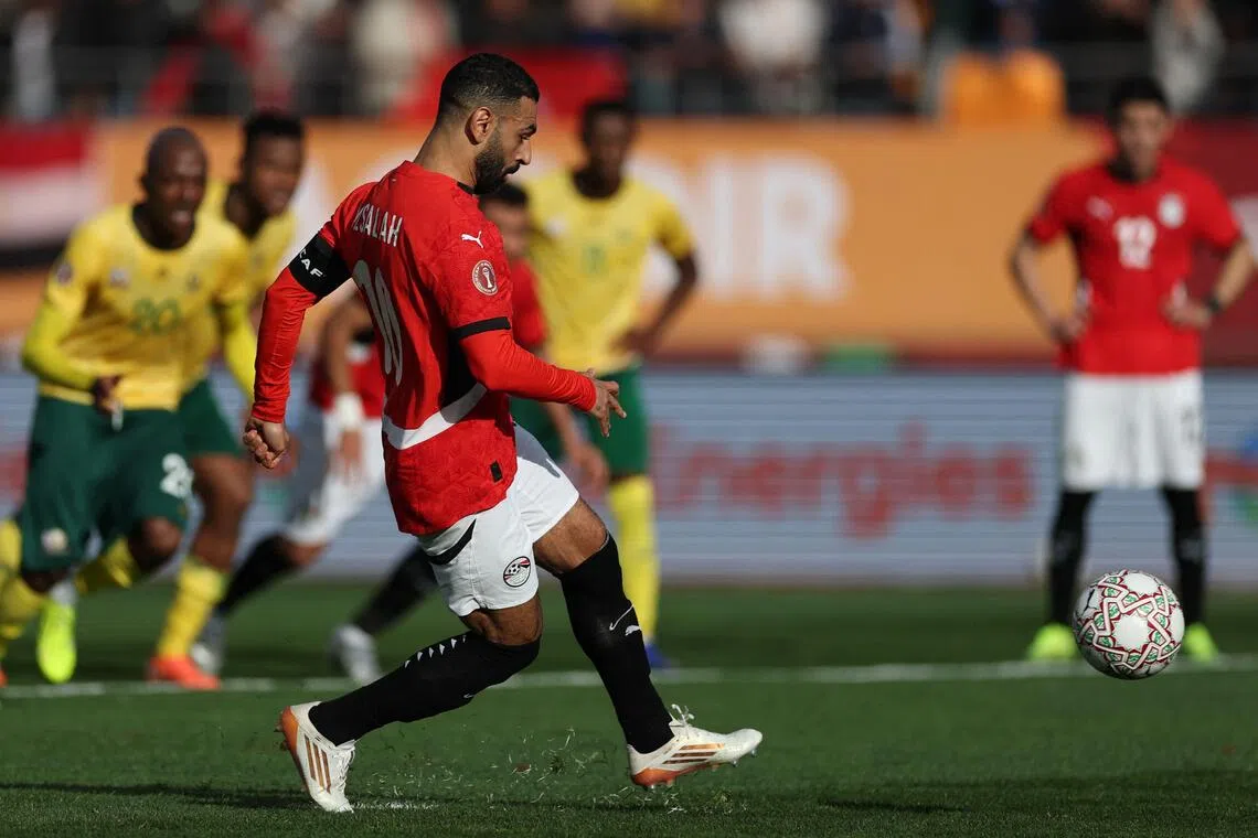 Egypt's forward #10 Mohamed Salah shoots from the penalty spot to score the team's first goal during the Africa Cup of Nations (CAN) Group B football match between Egypt and South Africa at Adrar Stadium in Agadir on December 26, 2025. (Photo by FRANCK FIFE / AFP)