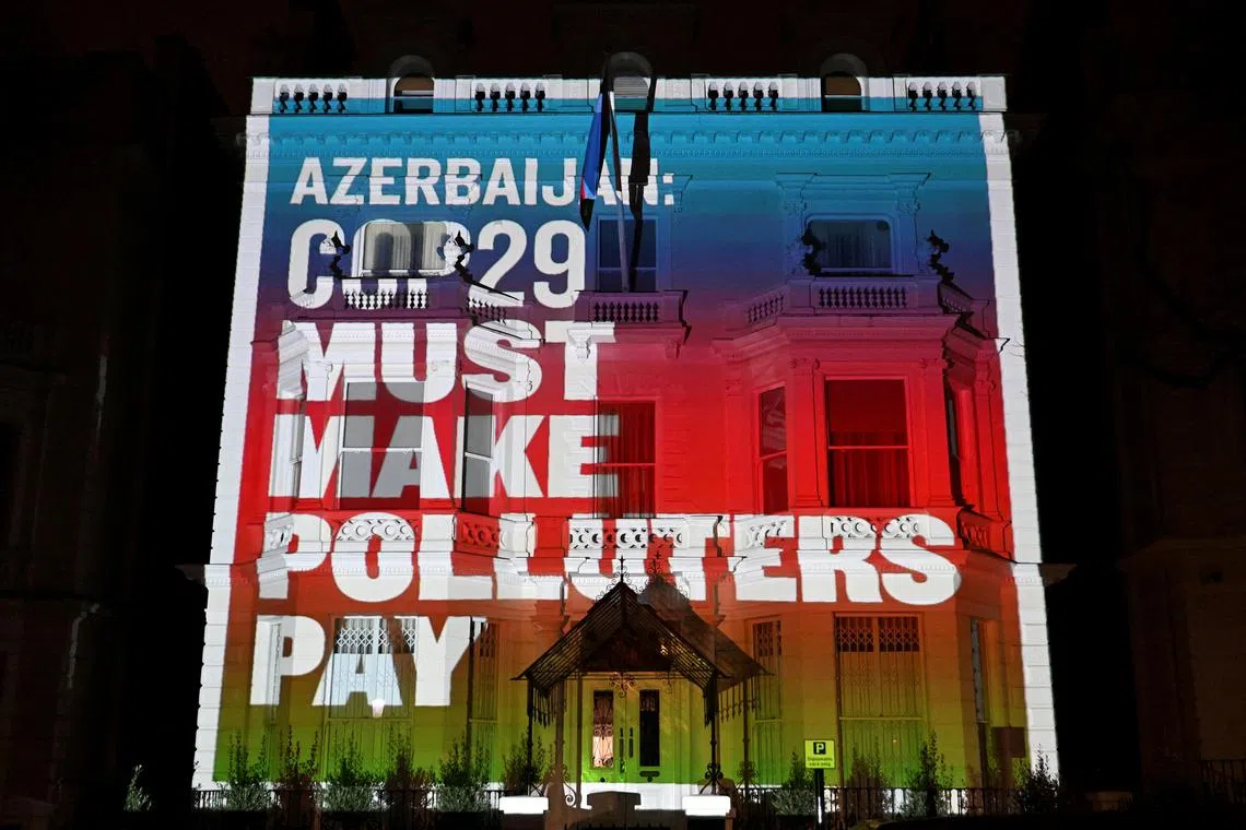Climate activists project a message ahead of COP29 climate talks in Baku, Azerbaijan.
