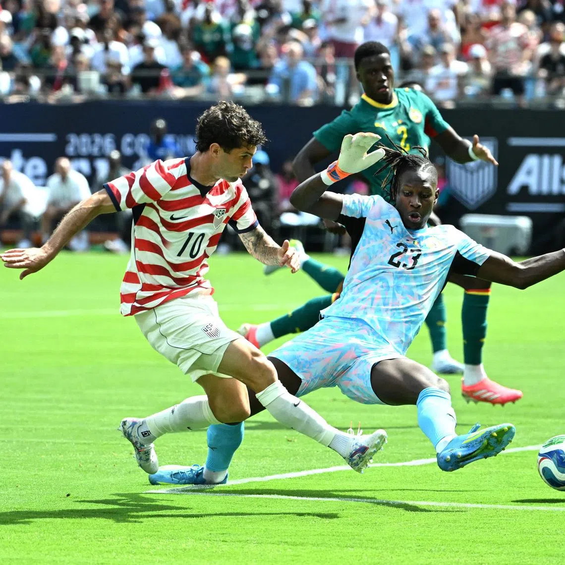 US talisman Christian Pulisic scoring past Senegal goalkeeper Edouard Mendy during the Americans' 3-2 friendly win on May 31.
