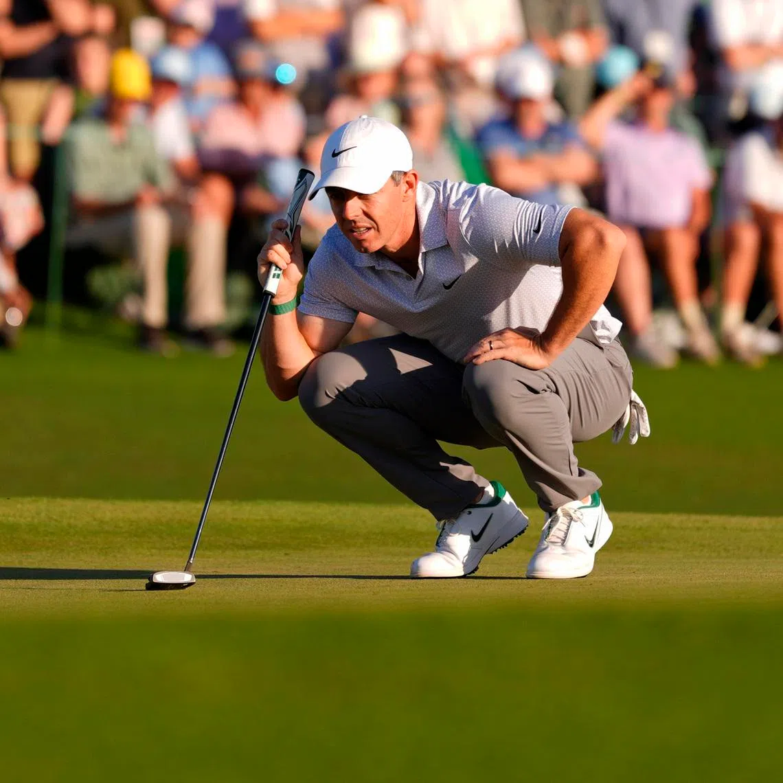 Rory McIlroy lines up a putt on the 18th green during the second round of the Masters Tournament at Augusta National Golf Club.