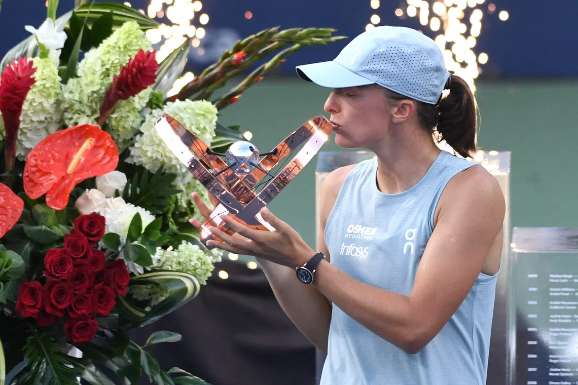 Aug 13, 2026; Toronto, Ontario, Canada; Iga Swiatek (POL) kisses the trophy after defeating Elena Rybakina (KAZ) during final round play at Sobeys Stadium. Mandatory Credit: Dan Hamilton-Imagn Images