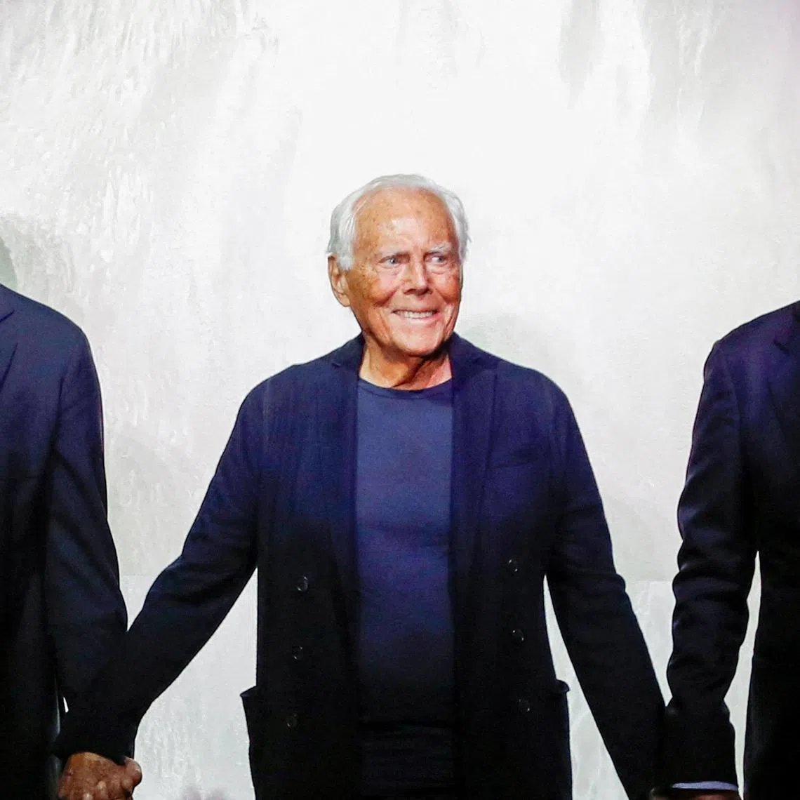FILE PHOTO: Italian designer Giorgio Armani acknowledges applauses with Leo Dell'Orco and Gianluca Dell'Orco at the end of his Spring/Summer 2025 collection during Fashion Week in Milan, Italy, June 17, 2024. REUTERS/Alberto Maddaloni/File Photo