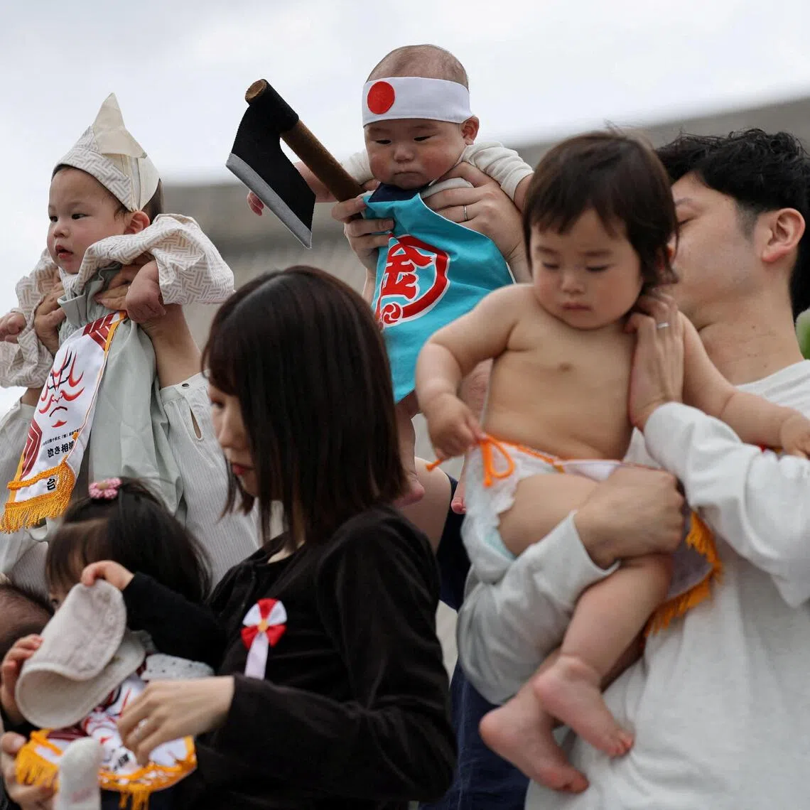 Babies and their parents take part in a ring-entering ceremony during “Nakizumo”, or a baby-crying sumo contest, at Sensoji Temple in Tokyo on April 25.