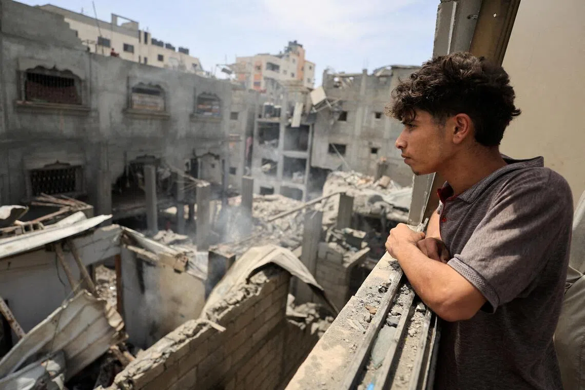 Palestinians inspecting the site of an Israeli air strike in Gaza City, on May 9.