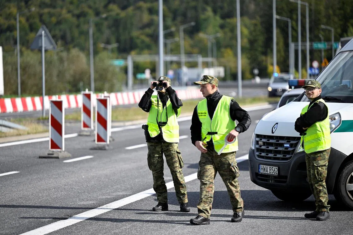 Polish border guards watch for vehicles at the border with Slovakia, in Zwardon, Poland, as part of security measures put in place to detect illegal migrants.