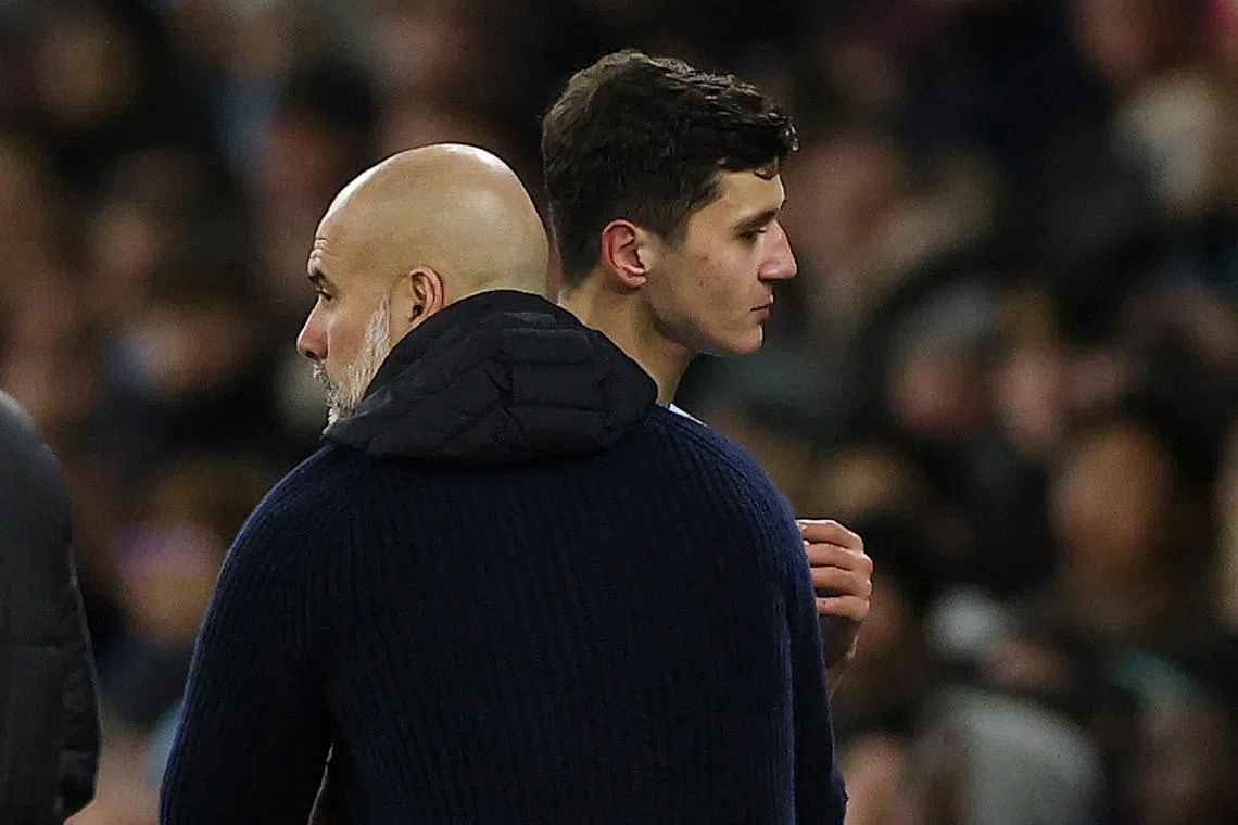 Soccer Football - Premier League - Manchester City v Chelsea - Etihad Stadium, Manchester, Britain - January 25, 2025 Manchester City's Abdukodir Khusanov with Manchester City manager Pep Guardiola after being substituted Action Images via Reuters/Lee Smith