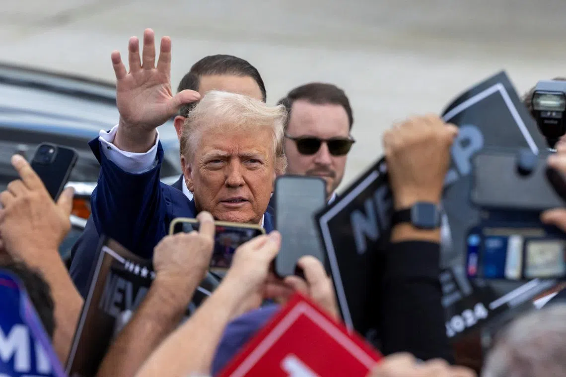 Republican presidential candidate and former U.S. President Donald Trump waves to supporters at Wayne County Airport in Romulus, Michigan, U.S. August 20, 2024.  REUTERS/Rena Laverty
