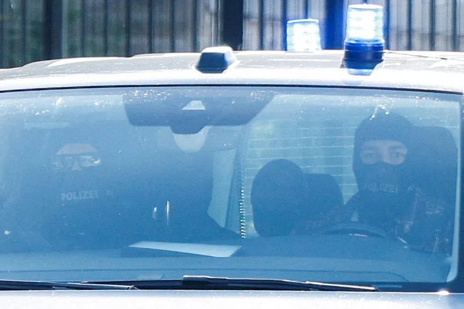 Police officers leaving the Federal Court of Justice in Karlsruhe, Germany, on Oct 7, following the detention of former German foreign intelligence chief August Hanning.