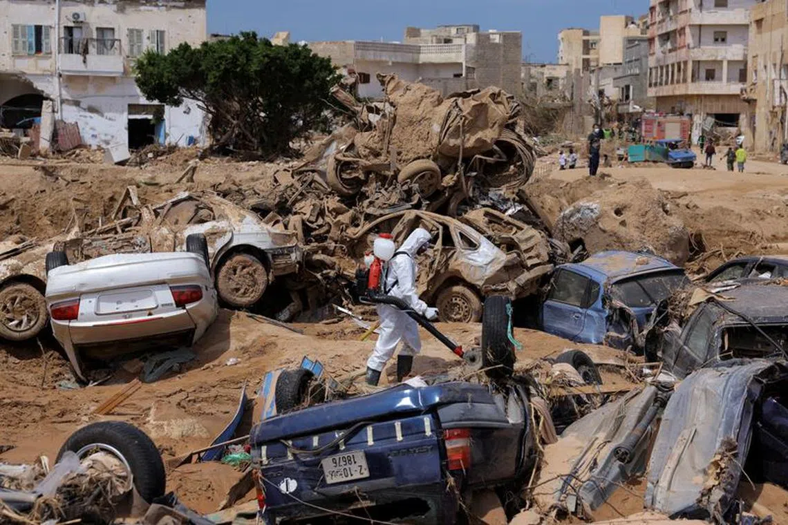 FILE PHOTO: A sanitation worker disinfects rubble, amid rising concerns of spread of infectious diseases, as dead bodies started to decompose, following fatal floods in Derna, Libya, September 17, 2023. REUTERS/Amr Alfiky