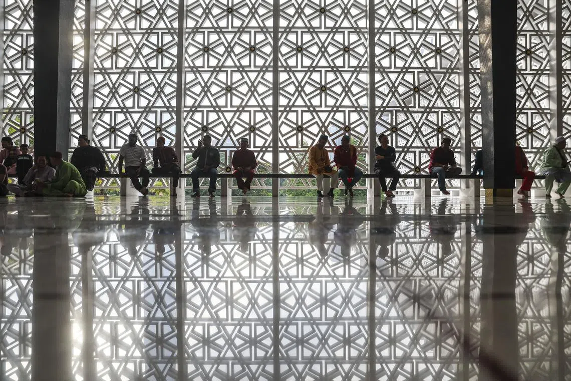 Muslim men waiting to particiapte in Eid al-Fitr prayers at the National Mosque in Kuala Lumpur, Malaysia, on April 10, 2024.
