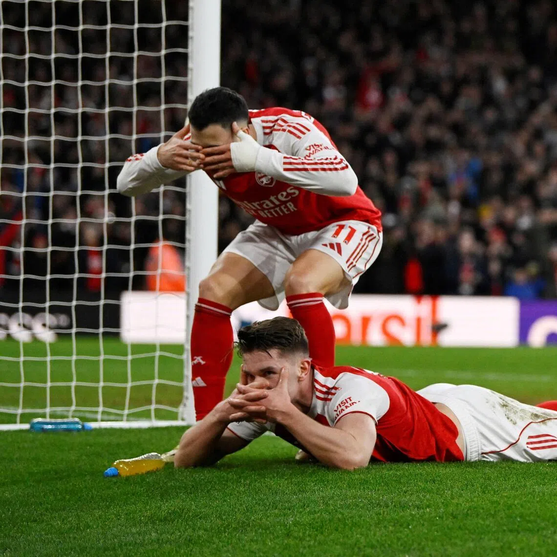 Arsenal's Viktor Gyokeres (lying down) celebrates scoring their third goal with Gabriel Martinelli during the 3-0 English Premier League win over Sunderland at the Emirates on Feb 7, 2026.