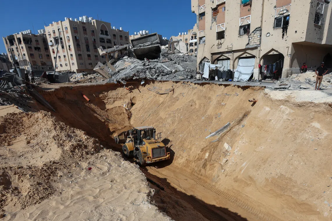 Heavy machinery operates at a site where searches for deceased hostages kidnapped by Hamas during the October 7, 2023, attack on Israel are underway amid a ceasefire between Israel and Hamas, in Khan Younis, southern Gaza Strip, October 19, 2025. REUTERS/Ramadan Abed