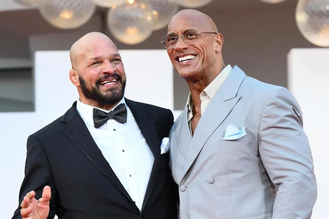 US former wrestler Mark Kerr (left) and US actor Dwayne Johnson arrive for the premiere of The Smashing Machine during the 82nd Venice International Film Festival in Venice, on Sept 1.
