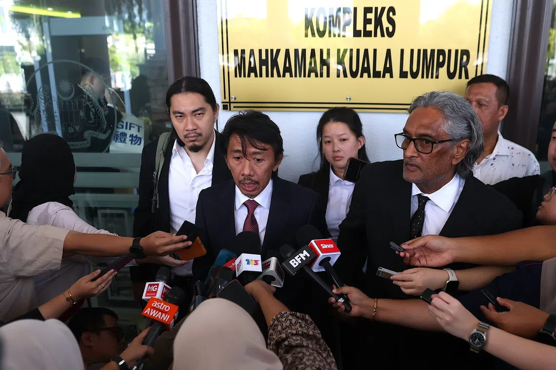 Lawyer of Ismail Sabri Yaakob, Amer Hamzah Arshad (centre) speaks to journalist at Kuala Lumpur Court Complex on Aug 7.