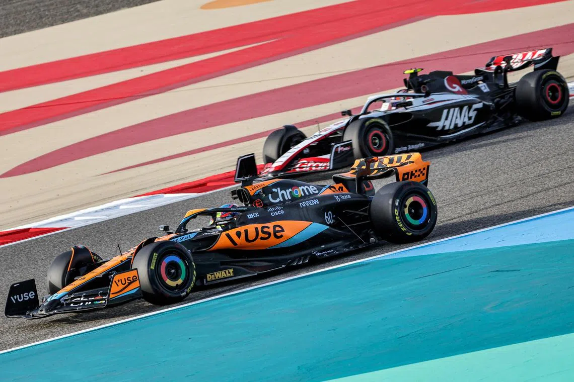 McLaren's Oscar Piastri (left) and Haas'  Nico Hulkenberg drive during the second day of Formula One pre-season testing.