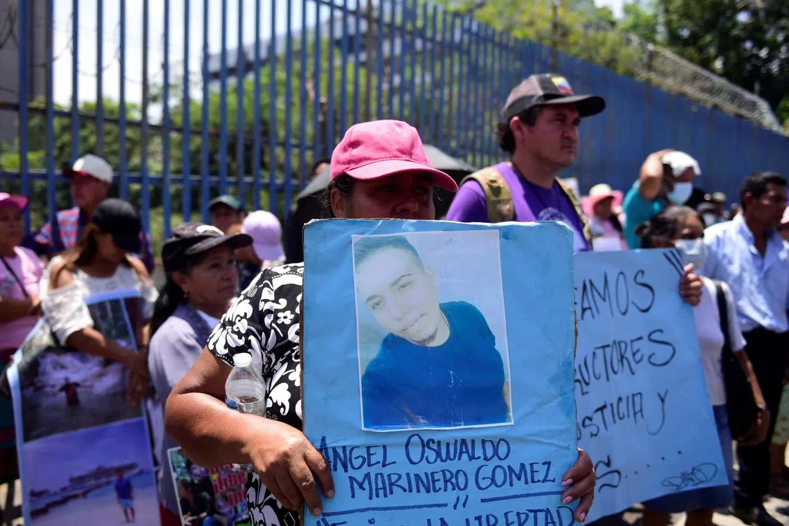FILE PHOTO: A woman holds a photo of her son during a protest to demand the release of people detained during the state of emergency decreed by the government to curb gang violence, in San Salvador, El Salvador, April 9, 2024. REUTERS/ Jessica Orellana/File Photo