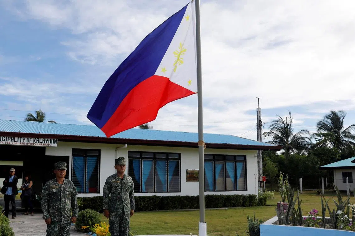 FILE PHOTO: Filipino soldiers stand at attention near a Philippine flag at Thitu island in disputed South China Sea April 21, 2017. REUTERS/Erik De Castro/File Photo