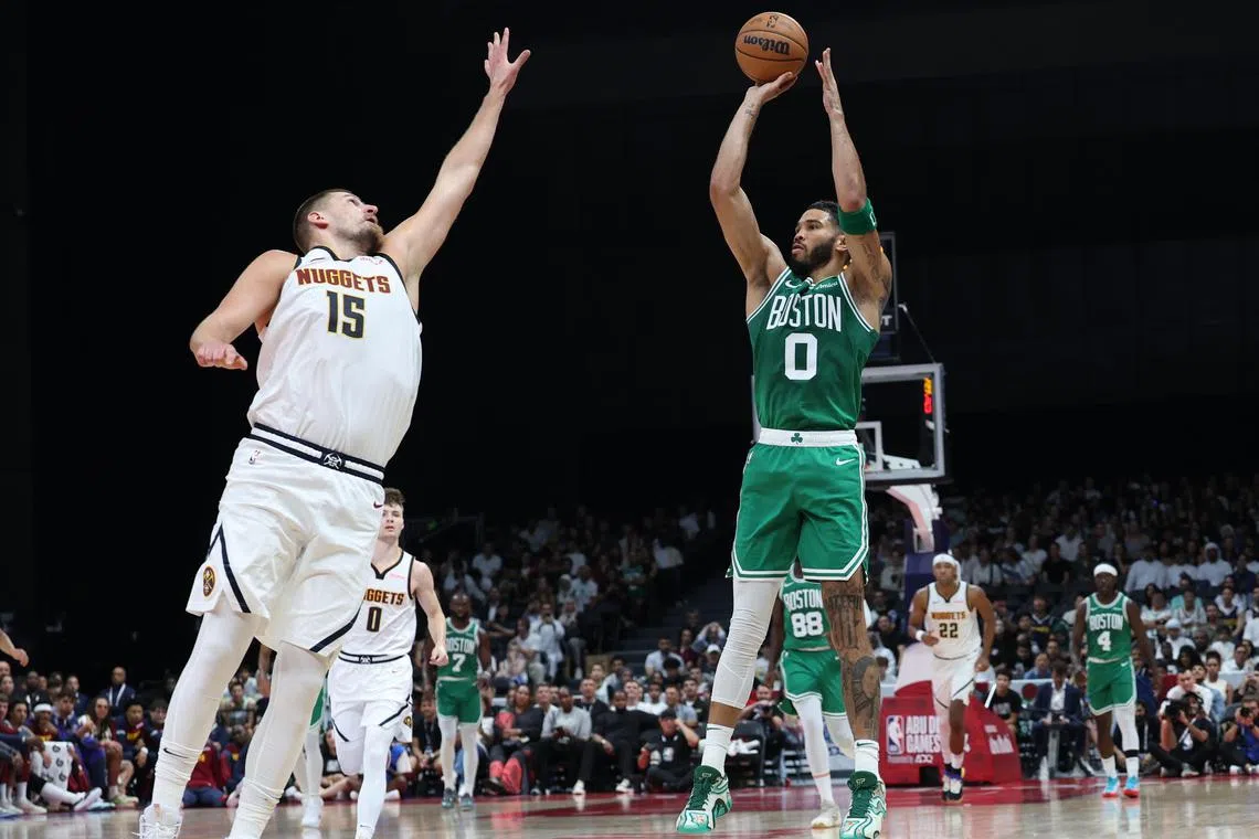 Jayson Tatum of the Boston Celtics shooting over Nikola Jokic of the Denver Nuggets during a pre-season game in Abu Dhabi.