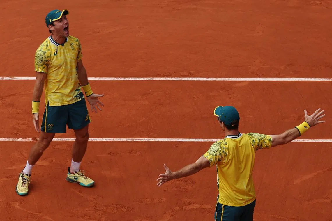 Paris 2024 Olympics - Tennis - Men's Doubles Gold Medal Match - Roland-Garros Stadium, Paris, France - August 03, 2024. Matthew Ebden of Australia and John Peers of Australia celebrate after winning gold against Austin Krajicek of United States and Rajeev Ram of United States. REUTERS/Claudia Greco
