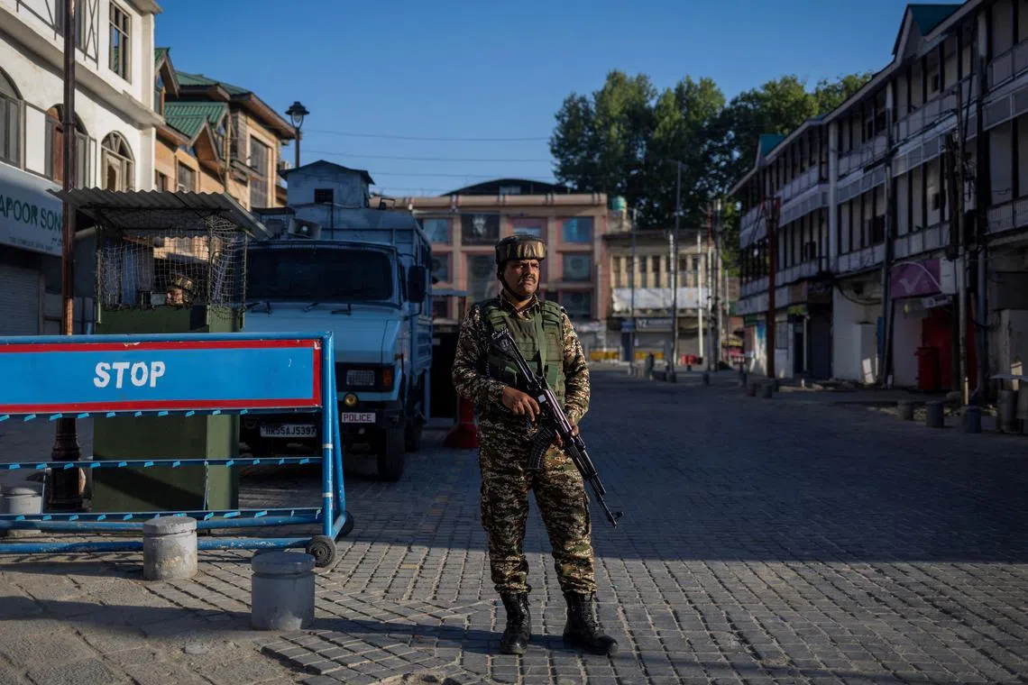 FILE PHOTO: An Indian security force personnel stands guard on a street, following an attack on tourists near Pahalgam in south Kashmir, in Srinagar, April 29, 2025. REUTERS/Adnan Abidi/File Photo