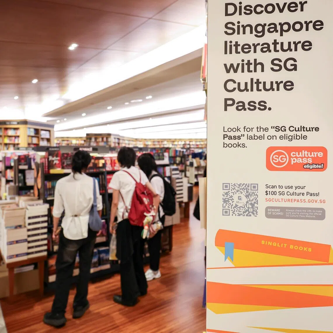 Book displays bearing SG Culture Pass stickers at Books Kinokuniya in Takashimaya Shopping Centre.