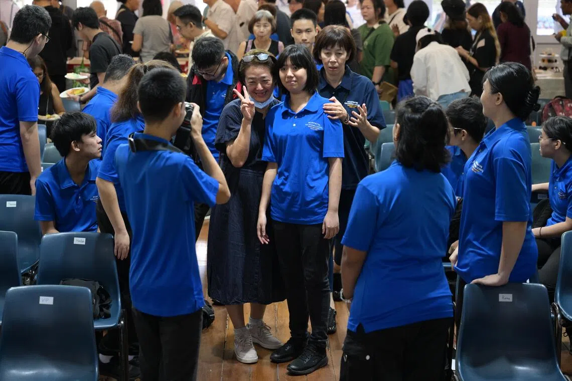 smmountbatten/ST20251120_202596800176/Ng Sor Luan/Mountbatten Vocational School (MVS) for special needs students will close by end of 2025. MVS holds its final year-end prize-giving ceremony and carnival on Nov 20, 2025. Educator Doreen Lim, 54, whose son is a student at the school takes photos with her son's classmate, Huang Meiru, 19.