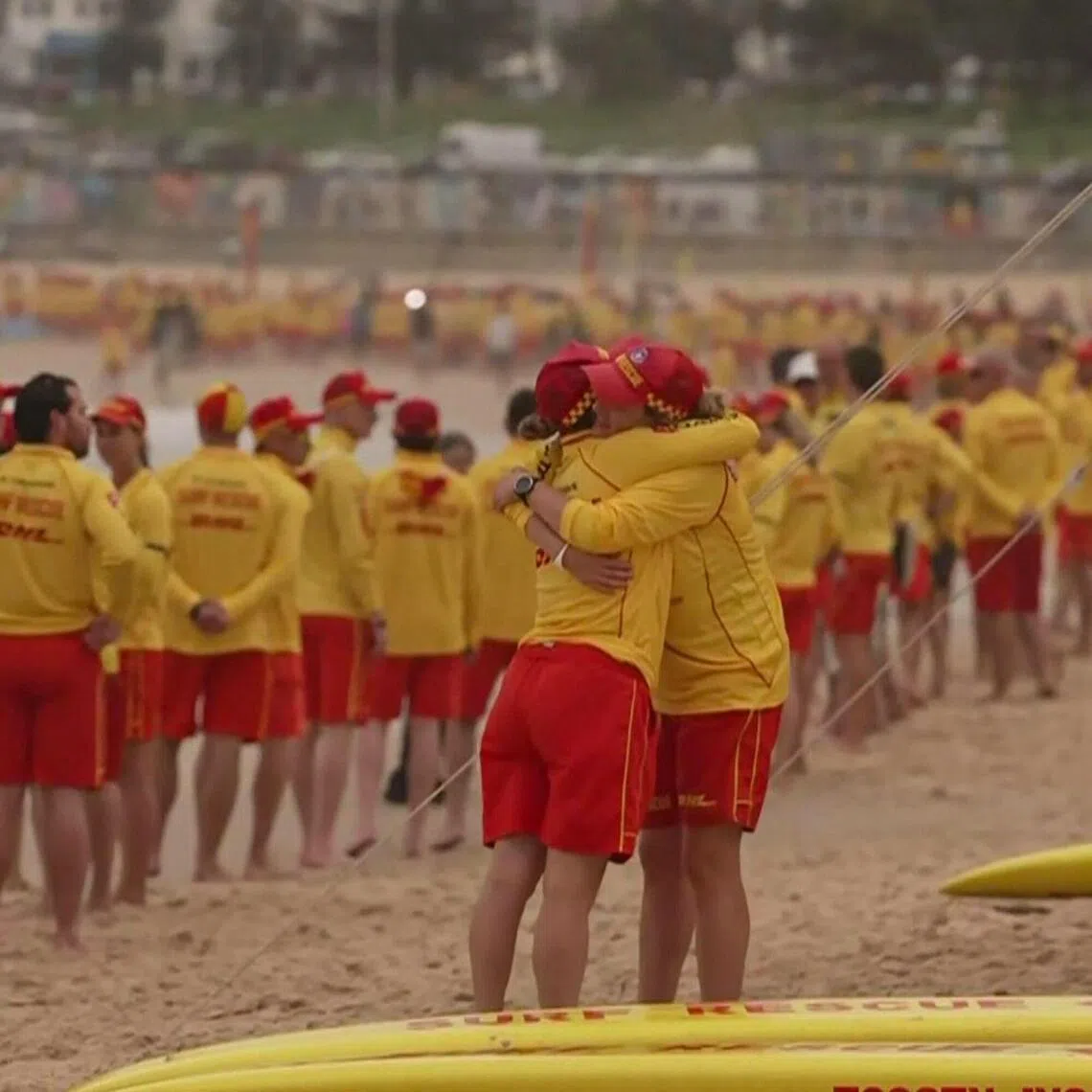 Australian surf lifesavers standing in silence on Bondi Beach in Sydney in honour of the victims of the Dec 14 shooting attack. 