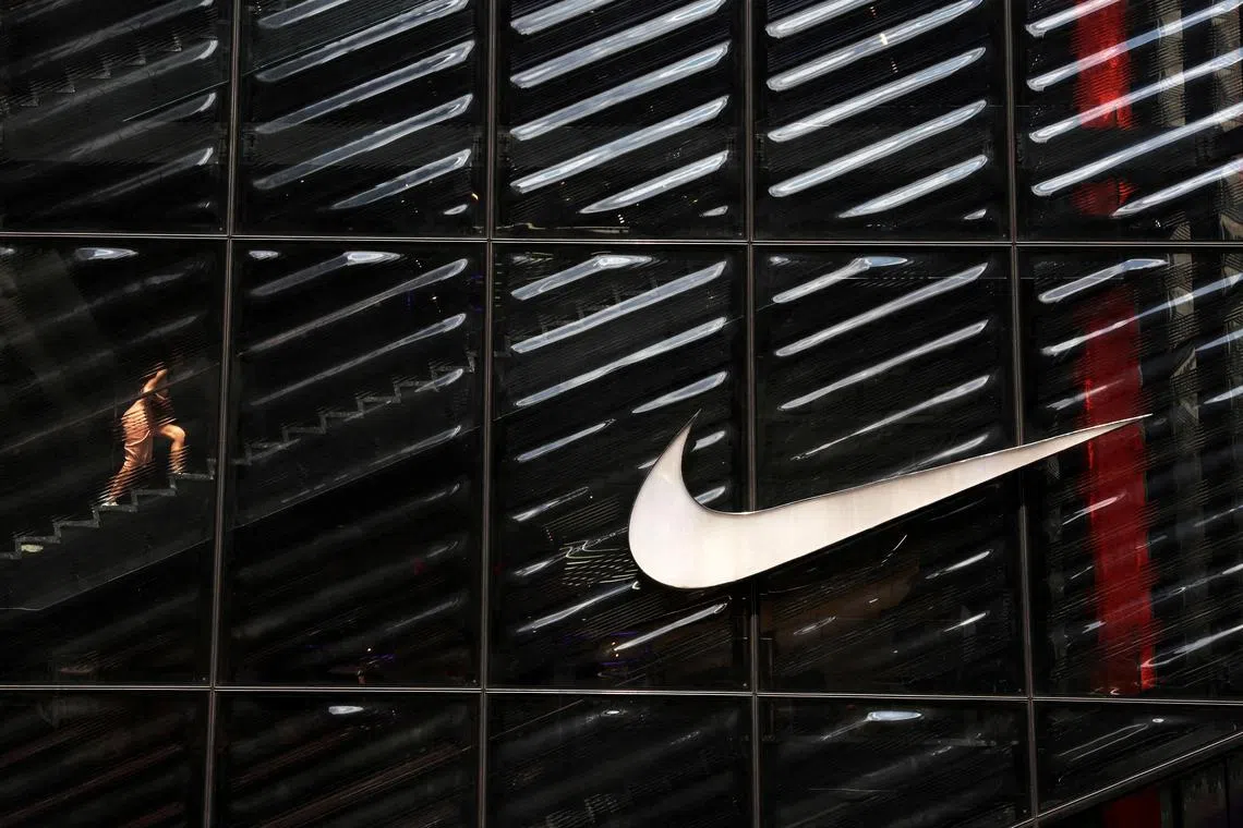 FILE PHOTO: A woman walks inside the Nike House of Innovation NYC on 5th Avenue in New York City, U.S., June 17, 2024. REUTERS/Shannon Stapleton/File Photo