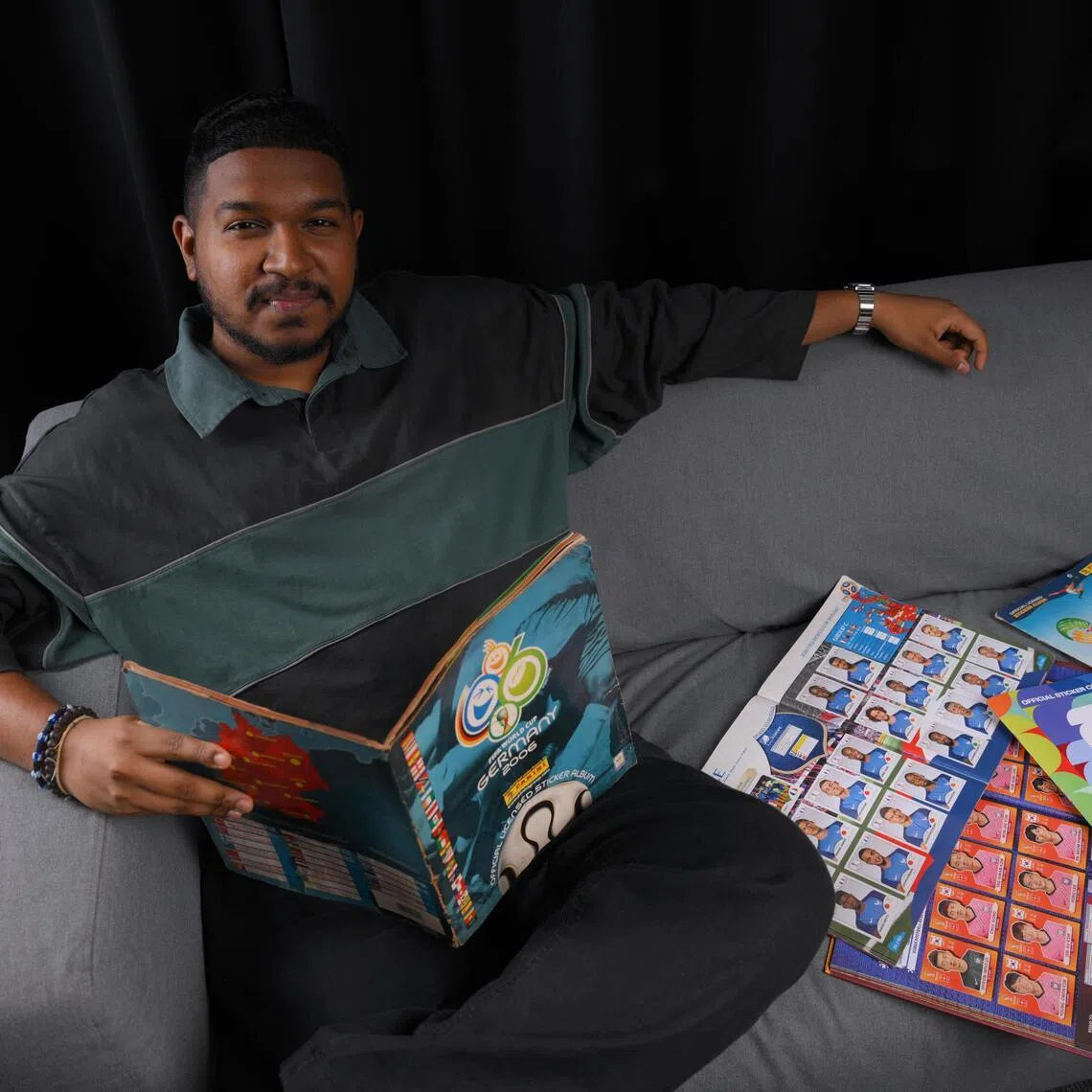 The Straits Times sports journalist Deepanraj Ganesan with his World Cup Panini sticker book collection.