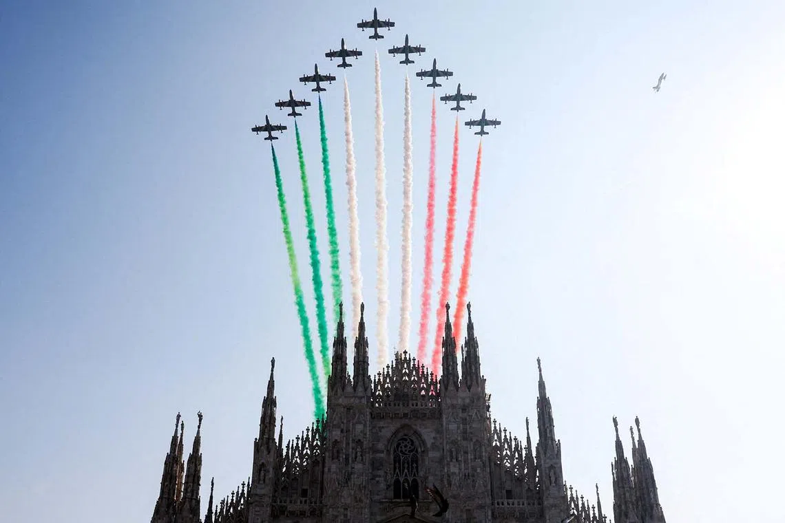 The Duomo Cathedral is seen as the Tricolor Arrows, the aerobatic demonstration team of the Italian Air Force, performs to mark the 100th anniversary of the foundation of the Italian military's air forces in Milan, Italy, Sept 11.