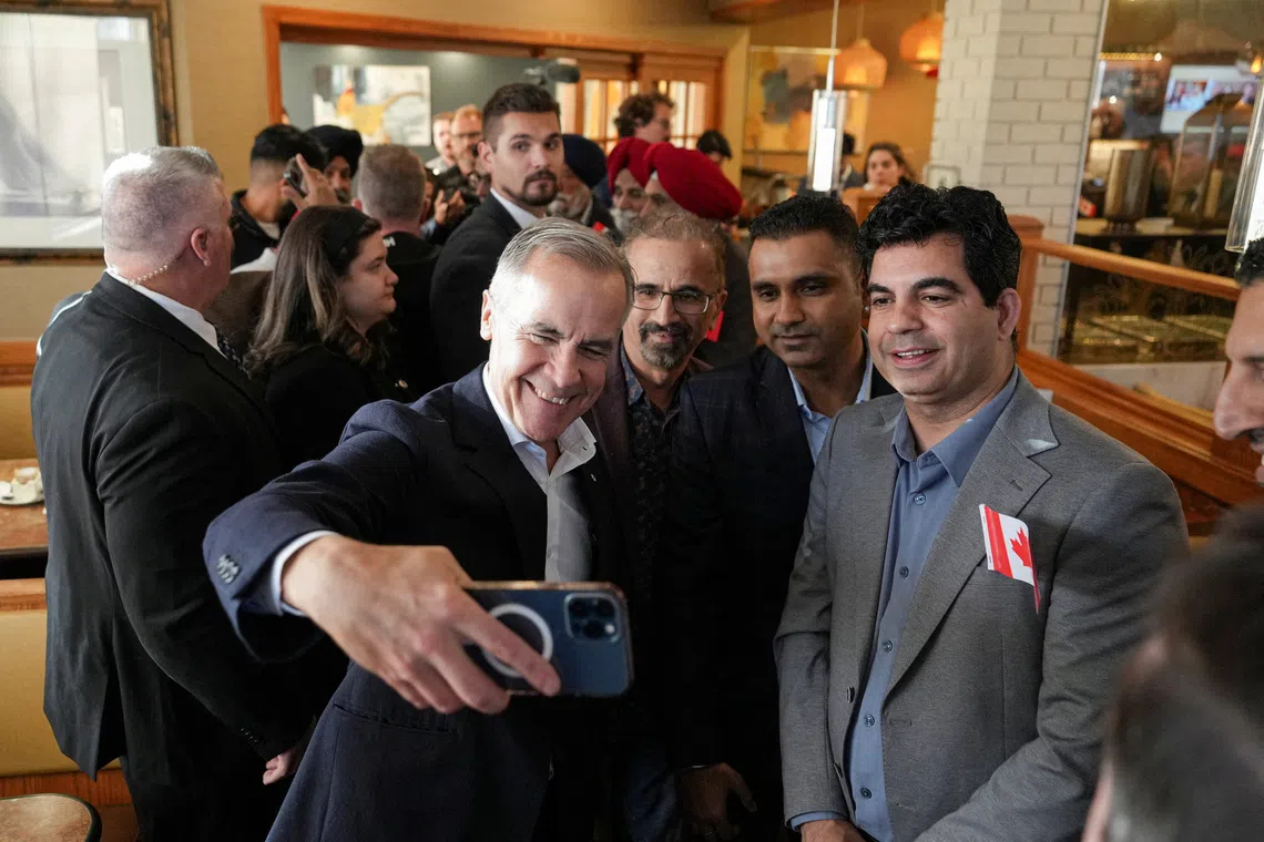 Canadian Prime Minister Mark Carney takes a wefie ahead of a non-binding referendum on Alberta sovereignty, in Calgary, Alberta, on Oct 15.