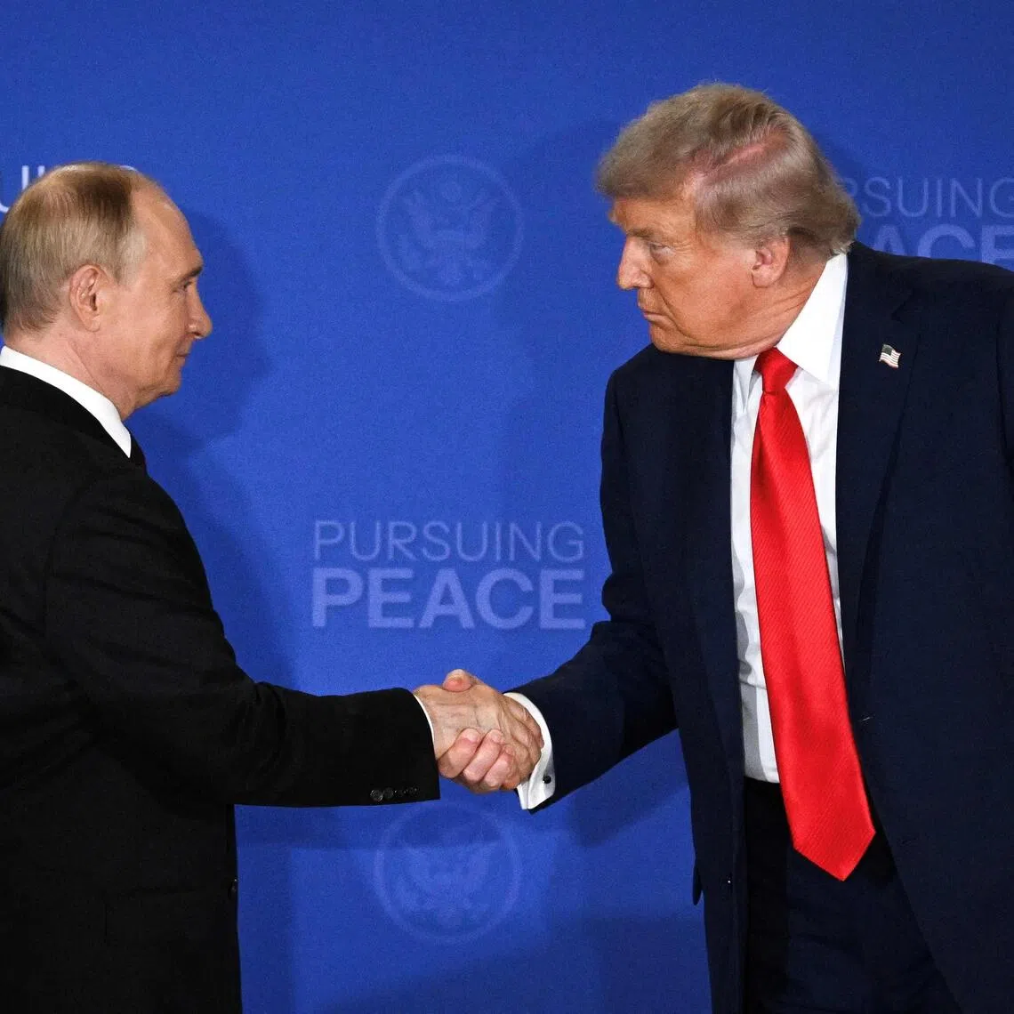 Mr Trump (right) said the meeting with Mr Putin (left) could take place within two weeks, though that timeline appears to be slipping away.