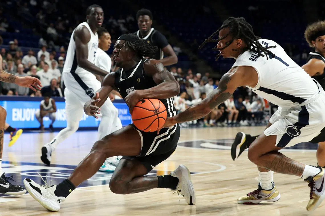 FILE PHOTO: Nov 20, 2024; University Park, Pennsylvania, USA; Penn State Nittany Lions guard Ace Baldwin Jr (1) reaches in and attempts to steal the ball from Purdue Fort Wayne Mastodons guard Rasheed Bello (0) during the second half at Bryce Jordan Center. Matthew O'Haren-Imagn Images/File Photo