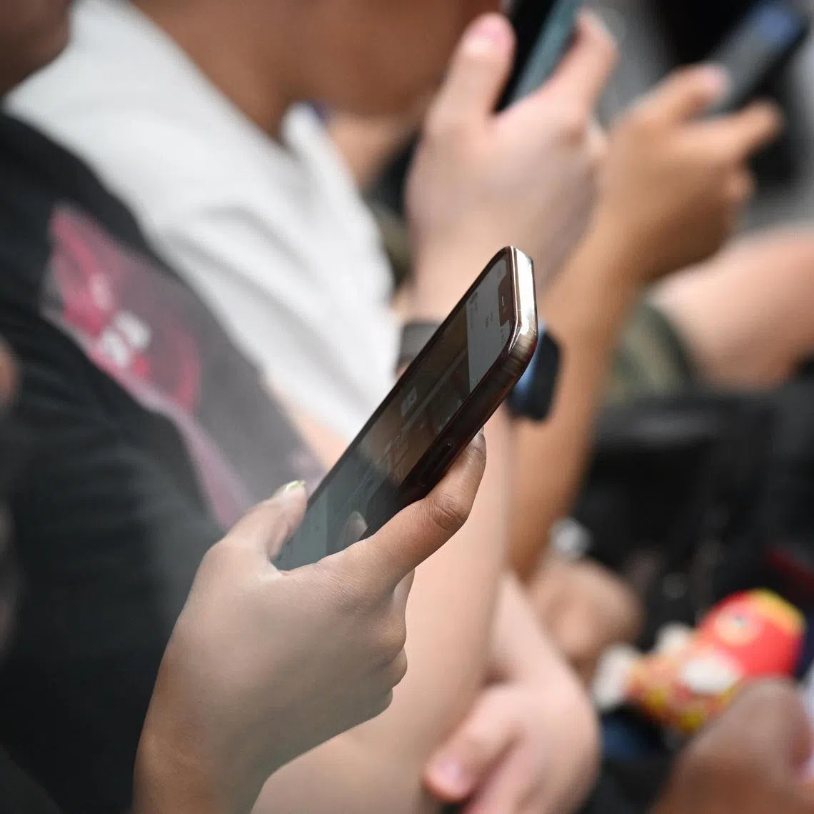 ST20250410_202561200104 Kua Chee Siong/ pixgeneric/
Generic pix of a commuters using their mobile phones/ handphones while travelling on an MRT train, on April 10, 2025.
Trump’s reciprocal tariffs kick in: Pricier phones, laptops in US and stymied global business flows. Smartphones are the largest import from China, with laptops coming in second. If the phones were to be made in the US, they could cost more than three times as much. As the Trump tariffs kick in, makers of computers, consumer electronics and other tech products face the prospect of "demand destruction" curbing sales. Demand destruction is the hot phrase now among Wall Street analysts covering Apple (AAPL), Nvidia (NVDA) and other tech hardware stocks. Demand destruction is the second punch of a double whammy after tariffs increased the cost of selling imported products in the U.S. Manufacturers are likely to pass along those costs to enterprise customers and consumers at higher prices.